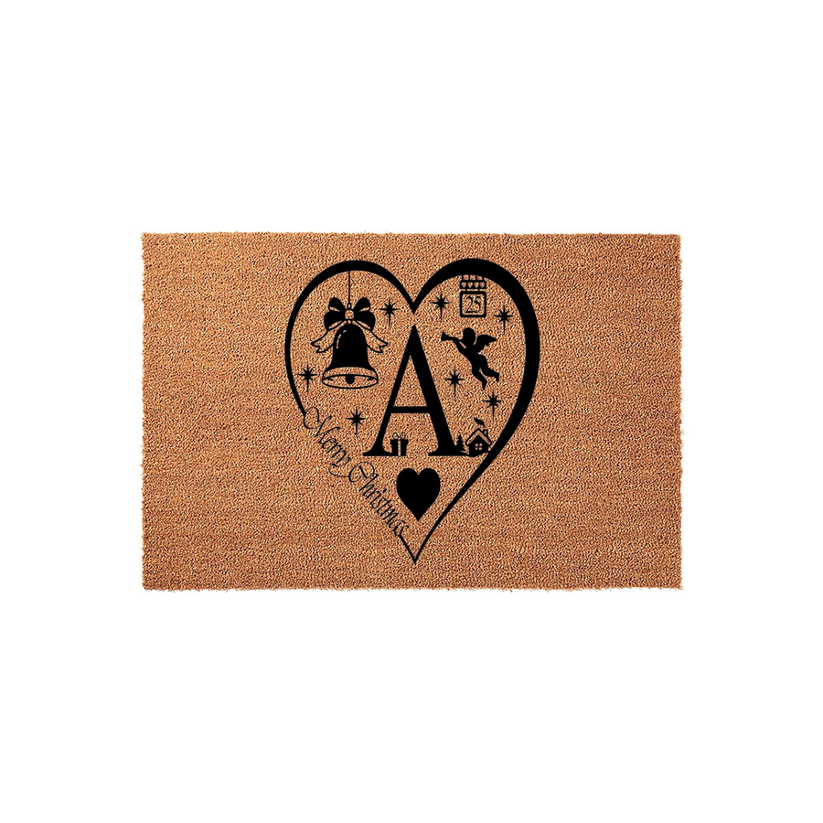 Personalized Christmas doormat featuring a large black heart design with a central initial, a festive bell, a small angel, and the words Merry Christmas printed on a natural brown coir fiber mat against a clean white studio