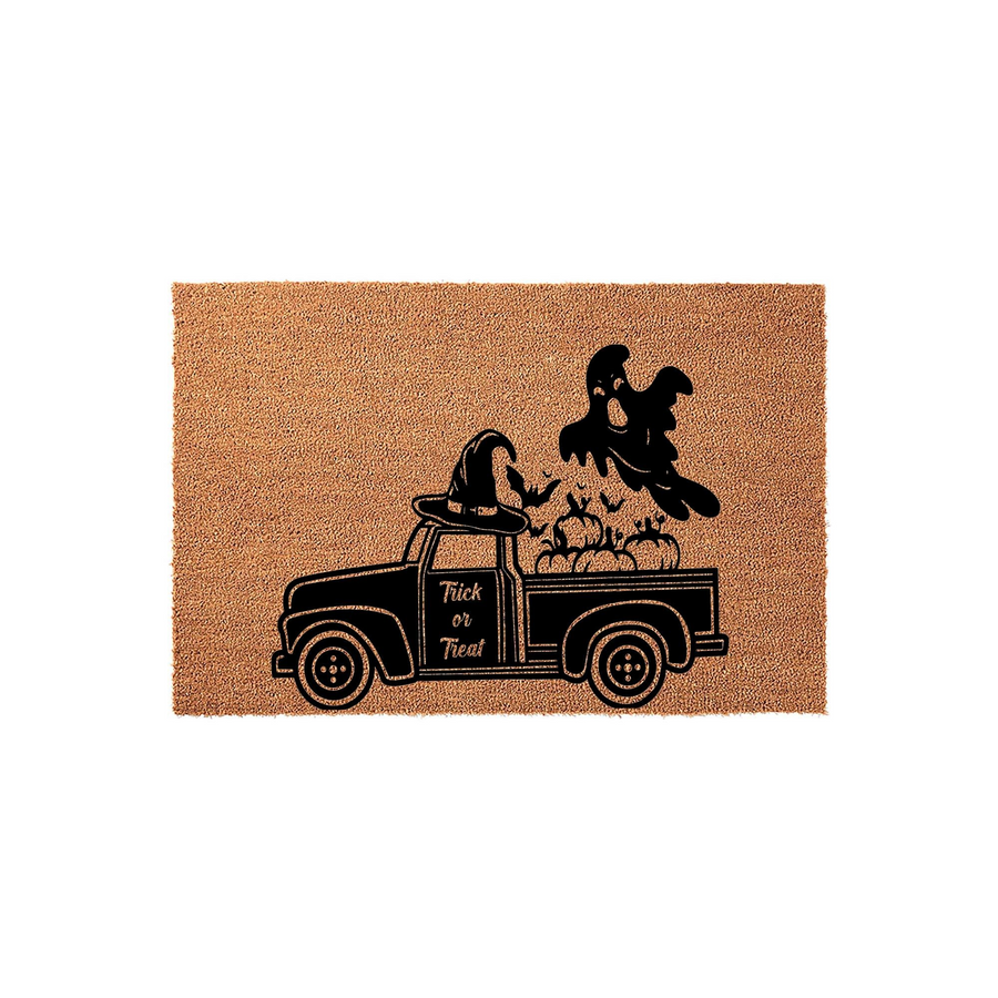 Trick or Treat Halloween doormat featuring a vintage truck illustration with a witch hat, pumpkins, and a ghost, printed in black ink on a natural tan coir fiber mat for a festive seasonal entryway decoration.