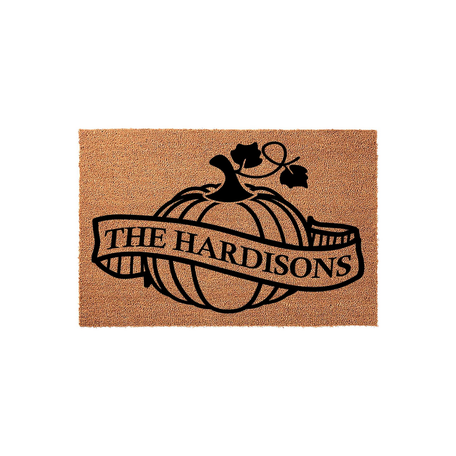 Personalized Fall Pumpkin Doormat featuring a natural coir texture with a black printed design of a large pumpkin and a banner across the center, providing a festive autumn welcome for your front porch with a custom family name.