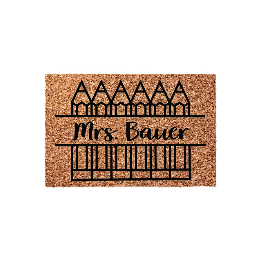 Personalized Teacher Classroom Doormat featuring a natural coir texture with a black graphic of pencils and a custom name line, creating a welcoming entrance for any school classroom or teacher office door on a clean white