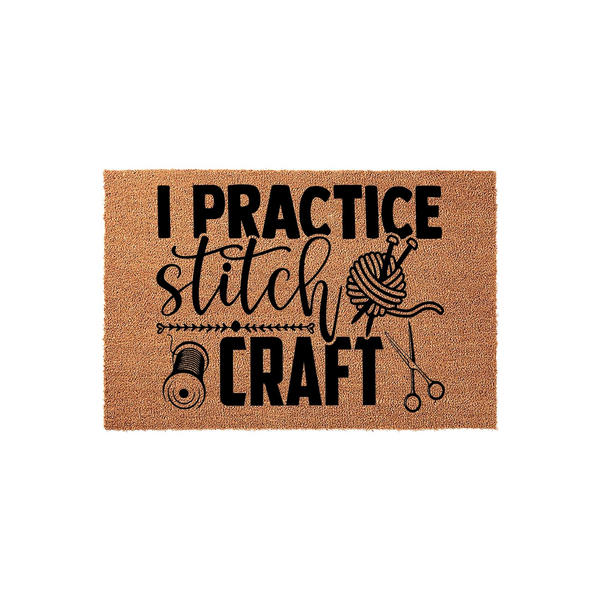 I Practice Stitch and Craft coir doormat featuring black printed text and illustrations of a yarn ball with knitting needles and scissors, set against a natural brown textured fiber background for a fun entryway decor statement