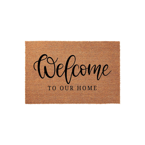 Welcome To Our Home Coir Doormat featuring a natural tan fiber texture and elegant black script lettering, providing a warm and inviting entrance for your front porch or entryway decor in a clean, studio-style product display.