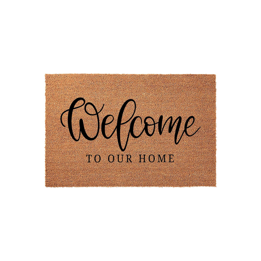 Welcome To Our Home Coir Doormat featuring a natural tan fiber texture and elegant black script lettering, providing a warm and inviting entrance for your front porch or entryway decor in a clean, studio-style product display.