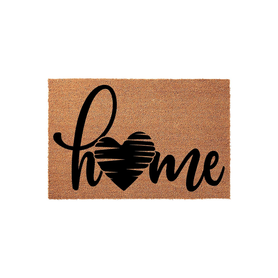 Home heart coir doormat featuring a natural brown fiber texture and bold black script lettering that spells out the word home, with a stylized heart replacing the letter o to create a warm and inviting entryway decor piece for