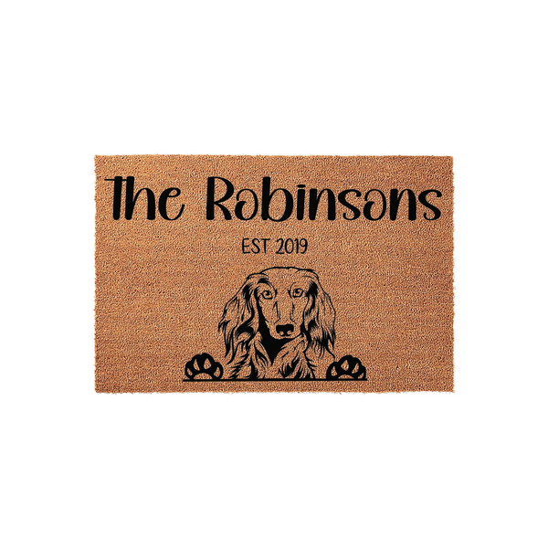 Personalized Dachshund doormat featuring a natural coir texture with a black printed illustration of a long-haired Dachshund peeking over the bottom edge, customized with a family name and established year on a clean white