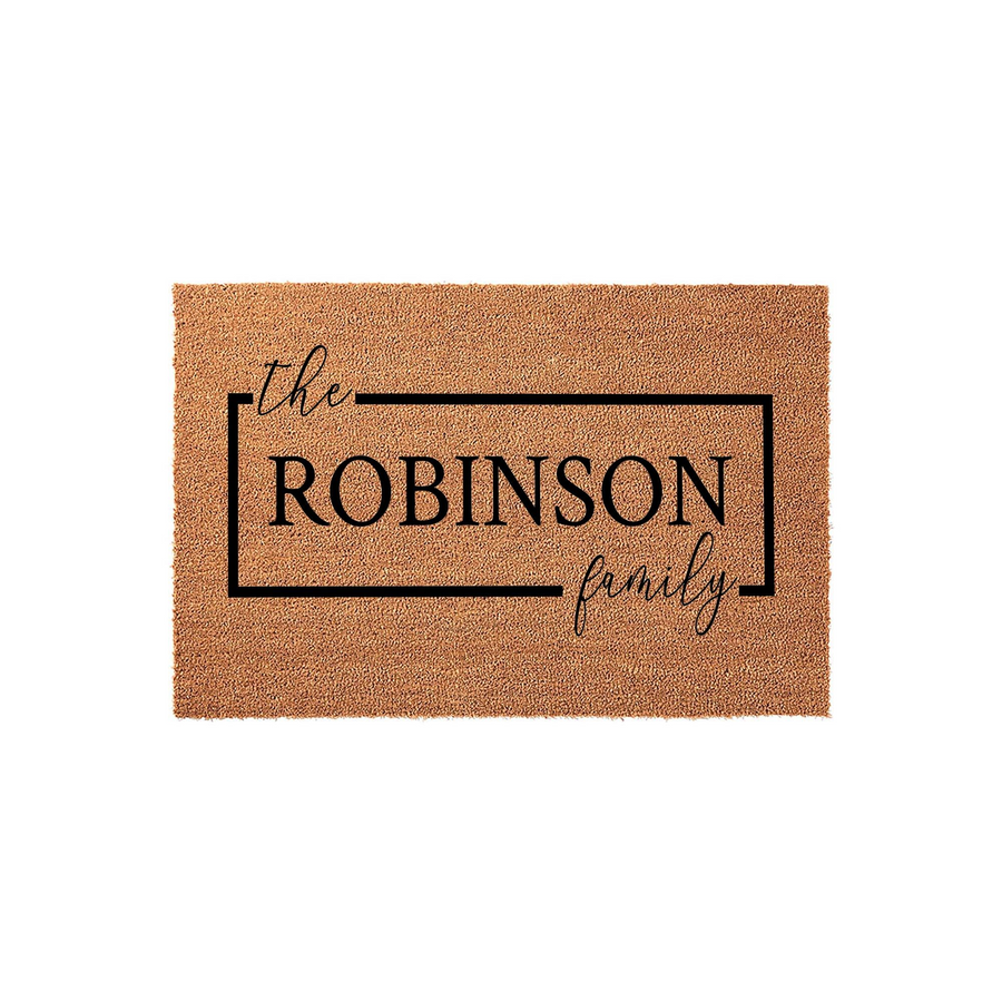 Personalized family name coir doormat featuring a clean rectangular border design with elegant script and bold typography, providing a welcoming entrance mat for any home front porch or entryway decor.