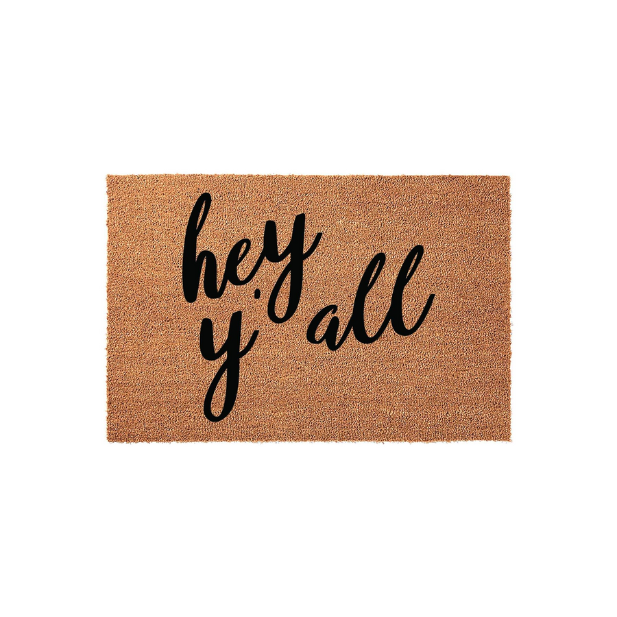 Hey Y'all Coir Doormat featuring a natural tan fiber texture and bold black script lettering that says Hey Y'all, making it a welcoming front porch decor piece for any home entrance that adds a touch of Southern charm to your
