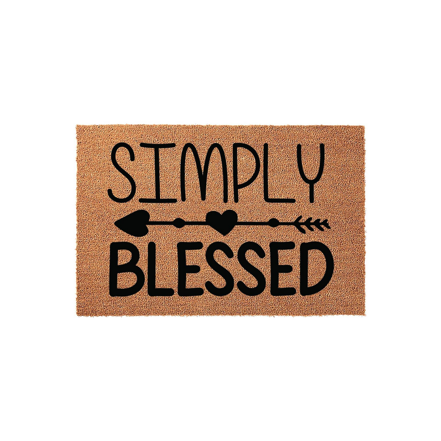 Simply Blessed coir doormat featuring a natural tan fiber texture with black text and a decorative arrow design with a heart in the center, providing a welcoming farmhouse style accent for your front porch or entryway floor decor.