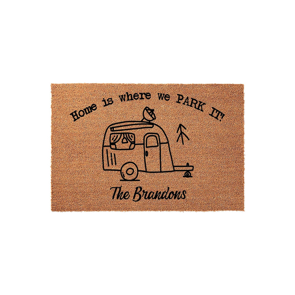 Personalized Camper Doormat featuring a natural coir texture with a black line-art illustration of a vintage travel trailer, the phrase Home is where we PARK IT, and space for a custom family name on a clean white studio