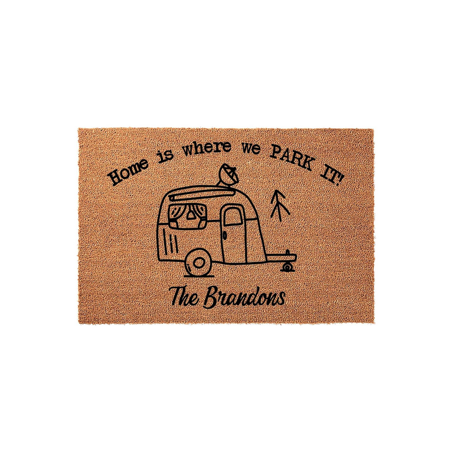 Personalized Camper Doormat featuring a natural coir texture with a black line-art illustration of a vintage travel trailer, the phrase Home is where we PARK IT, and space for a custom family name on a clean white studio