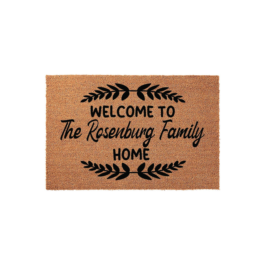 Personalized Family Name Coir Doormat featuring a rustic welcome design with black text and leaf accents on a natural tan fiber background, creating a warm and inviting entrance for any home or front porch decor setting.