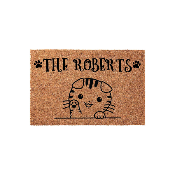 Personalized Cat Welcome Doormat featuring a cute illustrated tabby kitten waving from behind a line, with the family name space above and decorative paw prints on a natural coir fiber background for a charming home entryway