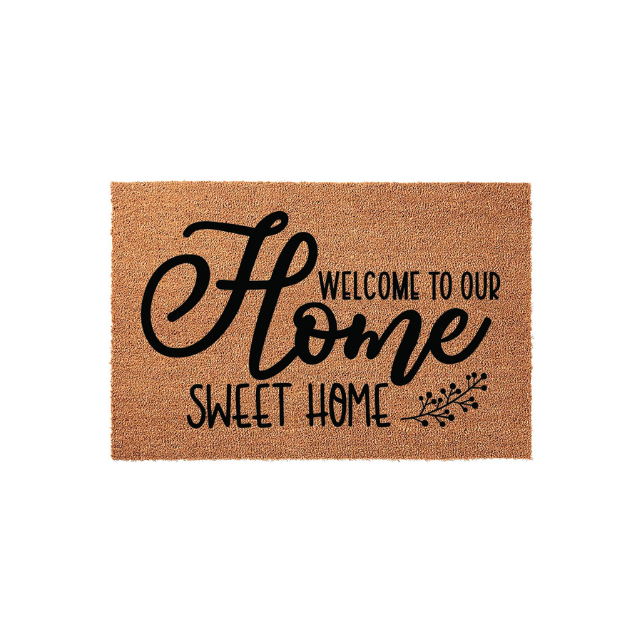 Home Sweet Home coir doormat featuring a natural tan fiber texture and bold black script lettering, designed as a welcoming front porch entrance mat for a house or apartment with a rustic farmhouse aesthetic and floral accents.