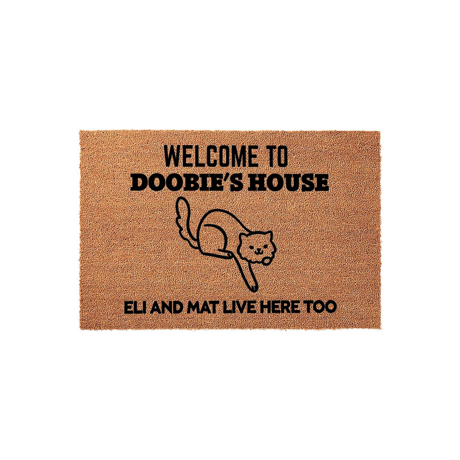 Personalized Cat Welcome Doormat featuring a cute line-art illustration of a cat and the text Welcome to Doobie's House, with additional text stating that others live here too, all printed on a natural brown coir fiber floor mat.