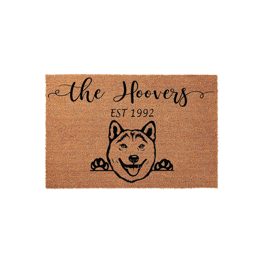 Personalized Shiba Inu doormat featuring a cute dog illustration peeking over the edge, customized with a family name and established year on a natural coir fiber background for a welcoming front porch entrance that celebrates