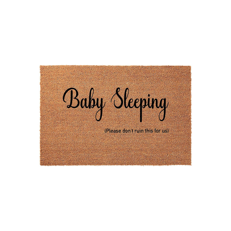 Baby Sleeping Doormat made of natural coir fiber with a humorous message printed in black script and sans-serif text, featuring a rectangular shape that is ideal for a front porch to alert visitors to keep quiet for a napping