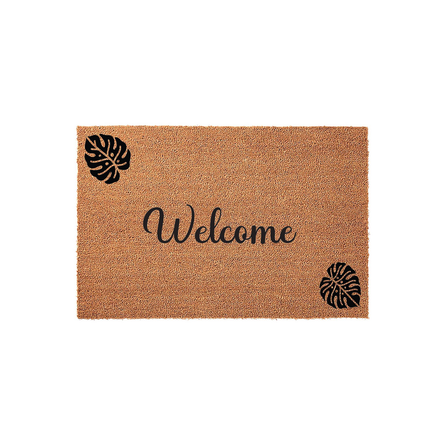Tropical Monstera leaf welcome doormat featuring a natural coir fiber texture with black printed monstera leaves in the corners and elegant cursive script text in the center, perfect for a modern farmhouse or botanical home