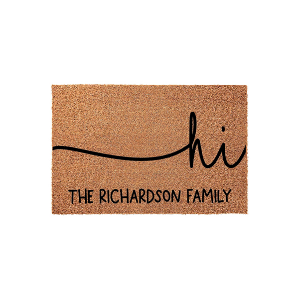 Personalized family name coir doormat featuring a minimalist black script design that says hi with a wavy line, providing a welcoming touch to any front porch entrance while showcasing a custom last name for a unique home decor