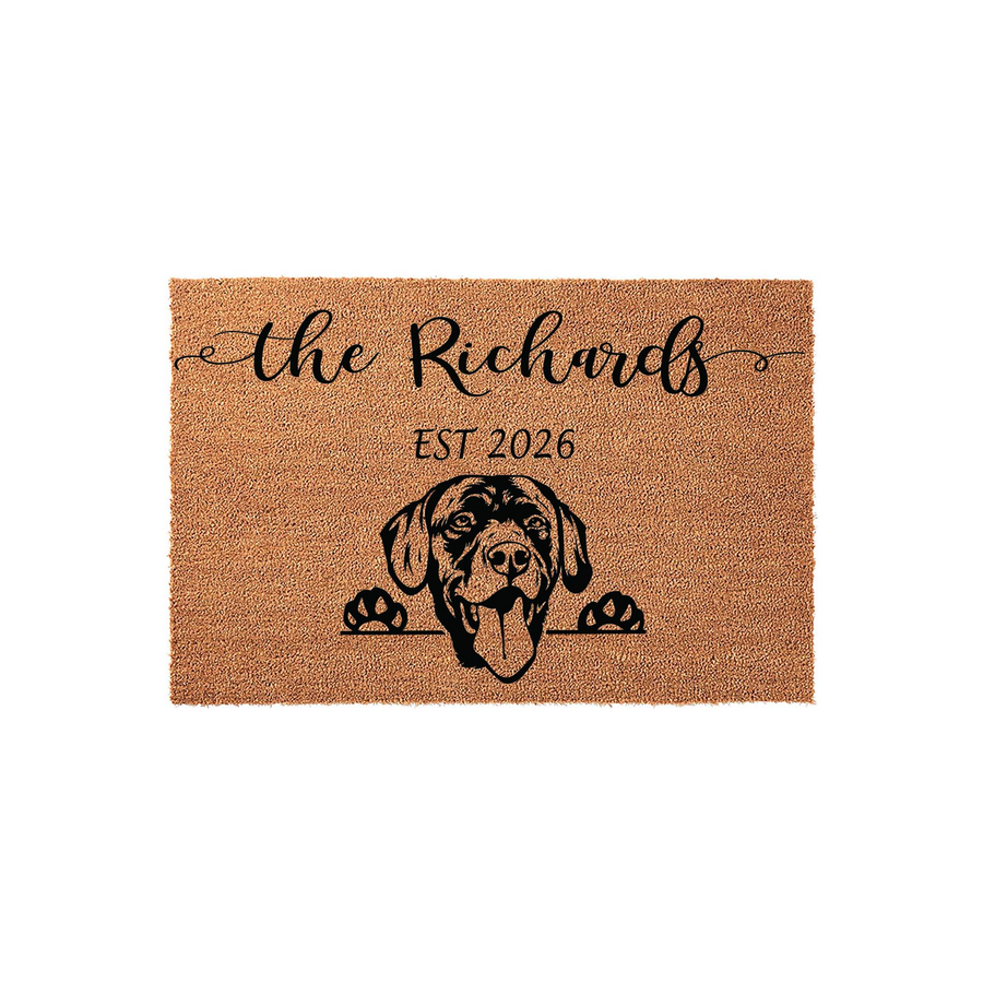 Personalized Labrador Retriever doormat featuring a natural coir texture with a black printed dog illustration, custom family name, and established year, creating a welcoming entrance for any dog-loving home on a plain white