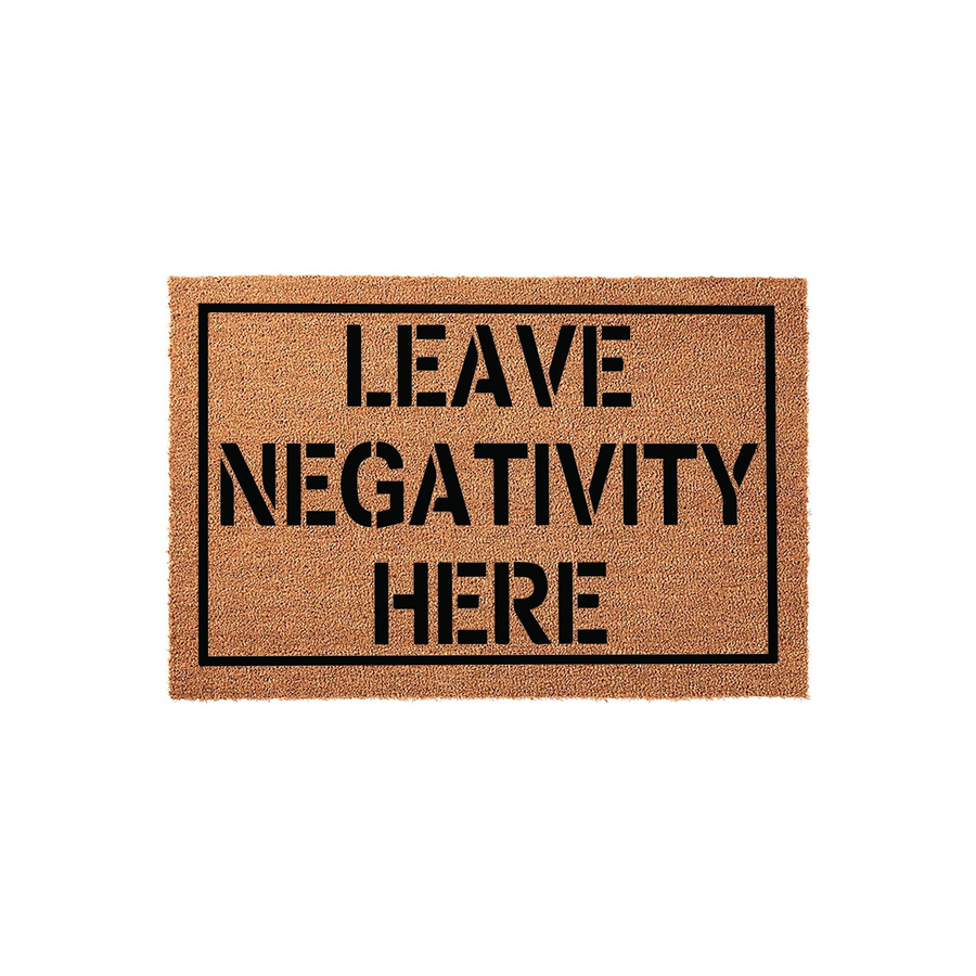 Leave Negativity Here coir doormat featuring a natural brown fiber texture and a bold black rectangular border, displaying the funny quote in clean, modern sans-serif lettering for a welcoming front porch entrance decor style.