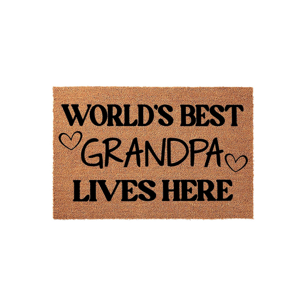World's Best Grandpa Coir Doormat featuring bold black text on a natural brown textured fiber background, with two small hand-drawn hearts flanking the word Grandpa to create a warm welcome for any front porch or entryway.