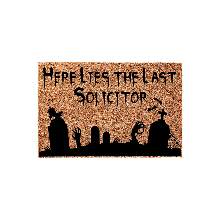 Funny Halloween doormat featuring a spooky graveyard silhouette with tombstones, a black cat, and reaching hands, printed with the text Here Lies The Last Solicitor on a natural coir fiber background for a festive front porch