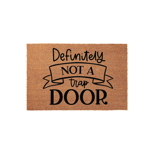 Definitely Not A Trap Door funny coir doormat featuring a humorous message printed in black ink on a natural brown coconut fiber mat, providing a playful and welcoming entrance decor piece for any home entryway or front porch