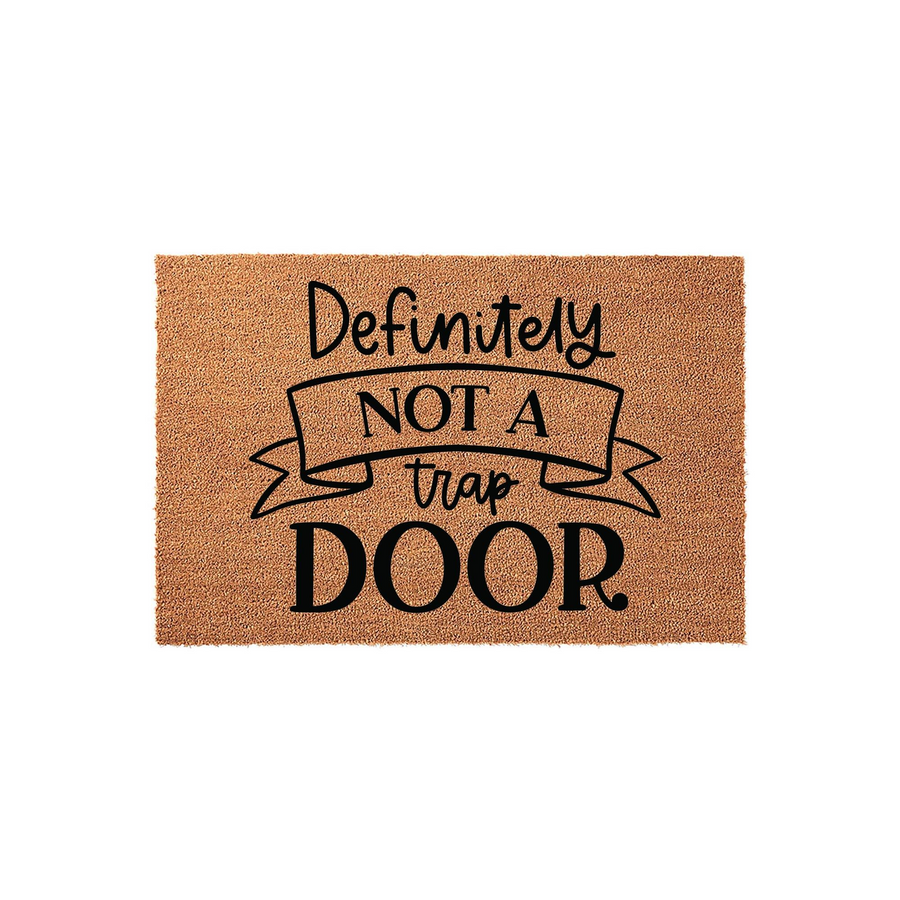 Definitely Not A Trap Door funny coir doormat featuring a humorous message printed in black ink on a natural brown coconut fiber mat, providing a playful and welcoming entrance decor piece for any home entryway or front porch