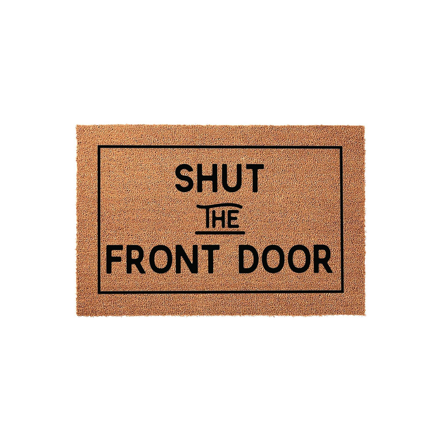 Shut the Front Door funny doormat featuring a natural coir texture and a bold black rectangular border, displaying the humorous phrase in a clean, modern sans-serif font against the rustic brown background for a welcoming