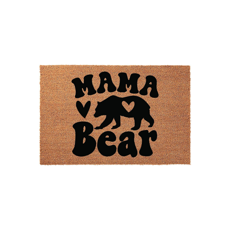 Mama Bear coir doormat featuring a rustic brown natural fiber texture with bold black lettering and a silhouette of a bear with a heart cutout, creating a charming and welcoming entrance decor piece for any home front porch.