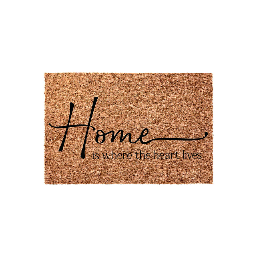 Home Is Where The Heart Lives Coir Doormat featuring a natural tan fiber texture and elegant black script lettering that reads Home is where the heart lives, creating a welcoming entrance for any front porch or entryway decor.