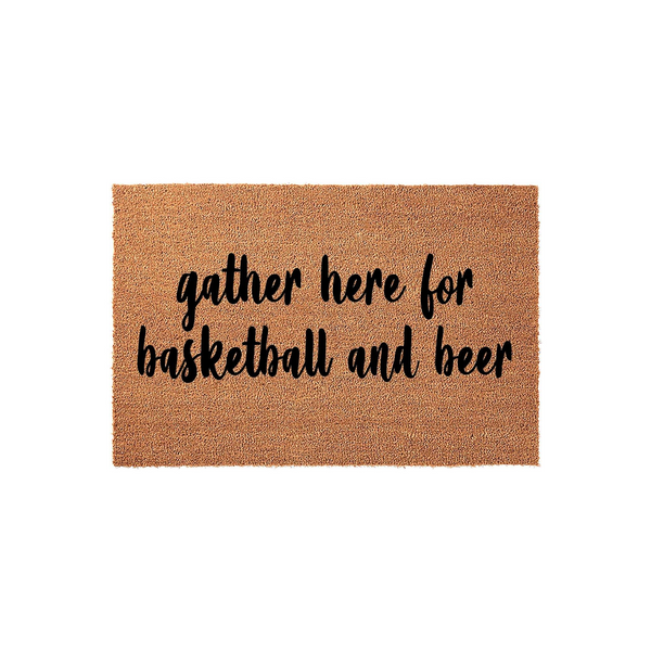 Basketball and beer coir doormat featuring a natural tan fiber texture and bold black script lettering that reads gather here for basketball and beer, making it a fun front porch decor piece for sports fans and home entertaining.