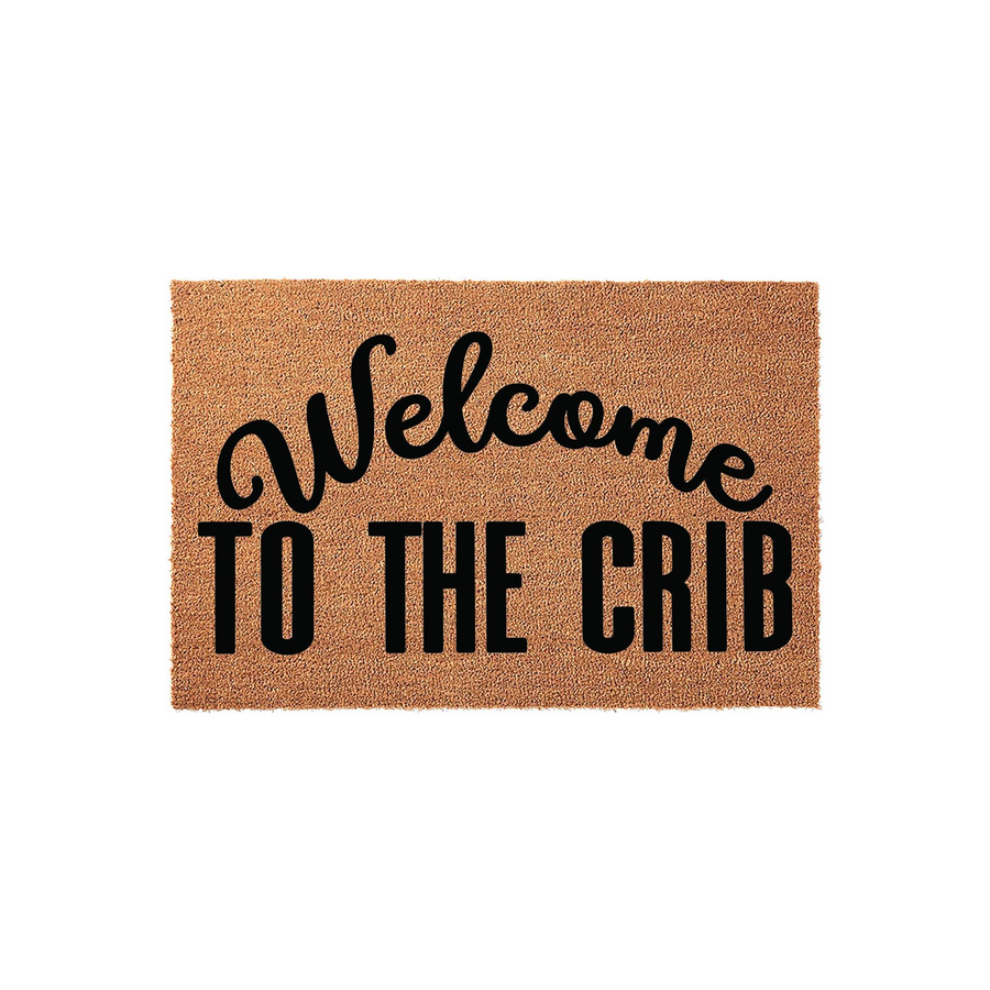 Welcome to the Crib coir doormat featuring a natural brown fiber texture and bold black lettering, designed as a humorous and stylish entryway floor mat for a new home or apartment entrance on a clean white studio background.