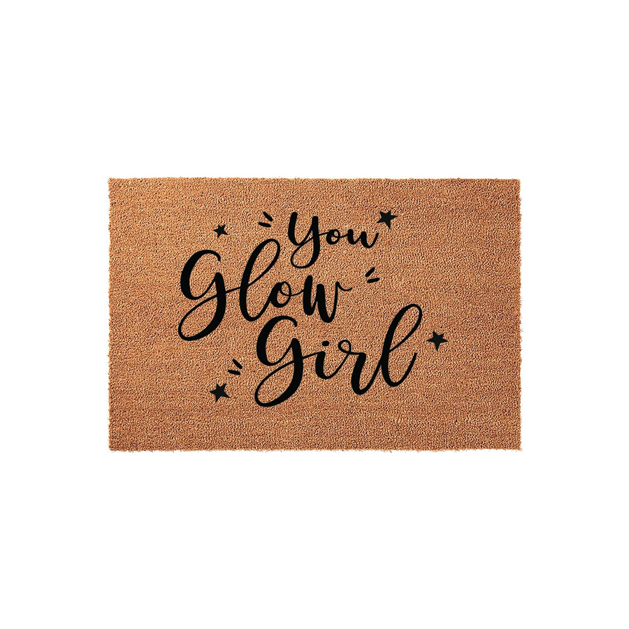 You Glow Girl coir doormat featuring natural brown coconut fiber material with black printed text and small star accents, displayed against a clean white background for a modern and welcoming entryway decor style.