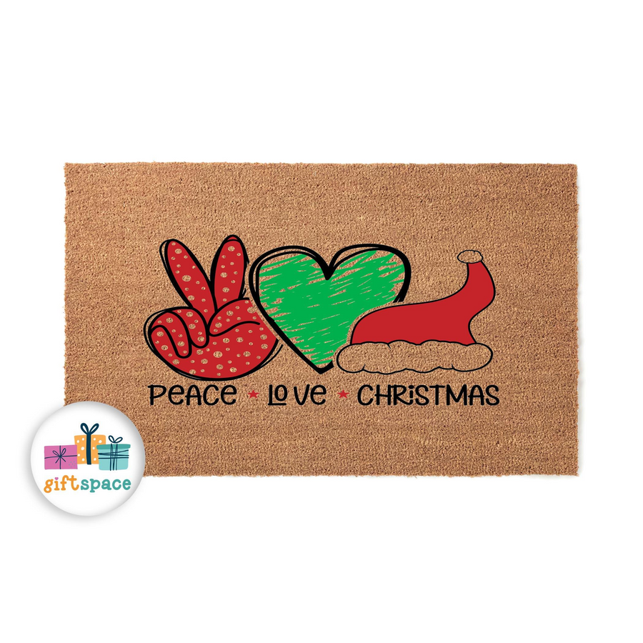 Peace Love Christmas coir doormat featuring a red polka dot peace sign, a green heart, and a festive Santa hat printed on a natural brown fiber mat, creating a cheerful holiday entryway decoration for your home during the winter