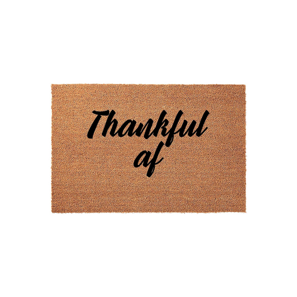 Thankful AF coir doormat featuring a natural brown fiber texture and bold black script lettering, providing a humorous and festive touch to your front porch decor for the autumn season or Thanksgiving holiday home entrance.