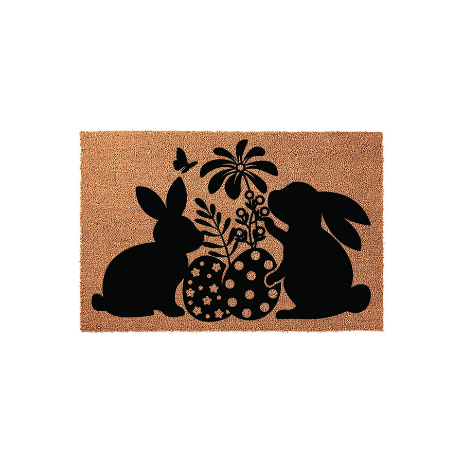 Easter Bunny Coir Doormat featuring a black silhouette design of two rabbits, patterned eggs, a flower, and a butterfly on a natural brown fiber background, creating a festive spring welcome for your front porch or entryway decor.
