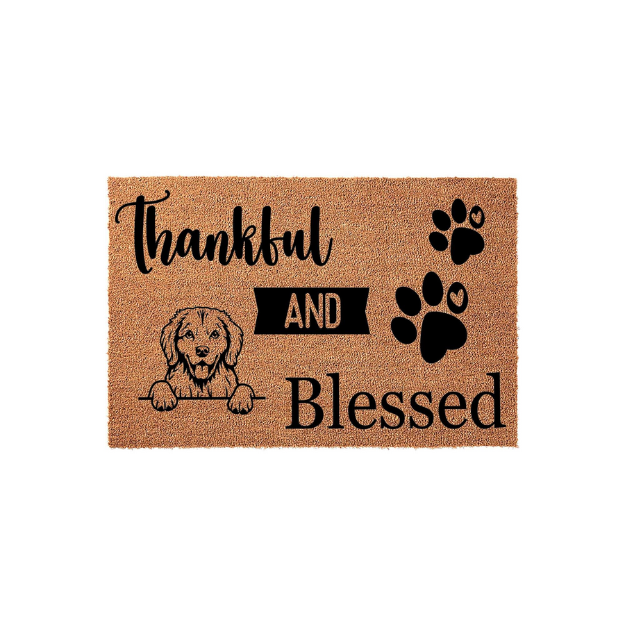 Golden Retriever Thankful and Blessed doormat featuring a cute dog illustration and paw prints on a natural coir fiber background, creating a welcoming entryway decor piece for any dog lover who enjoys rustic home accents.