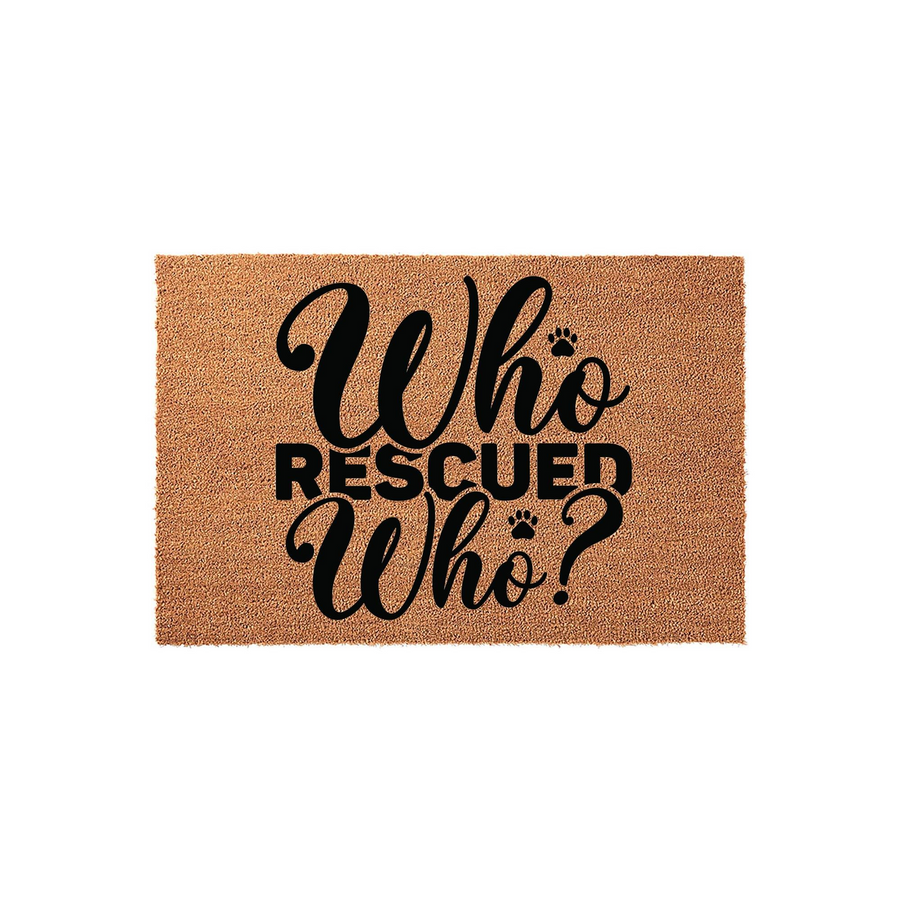 Who Rescued Who coir doormat featuring bold black text and small paw print accents on a natural brown fiber background, making a charming entryway rug for any pet lover who enjoys celebrating their adopted dog or cat rescue