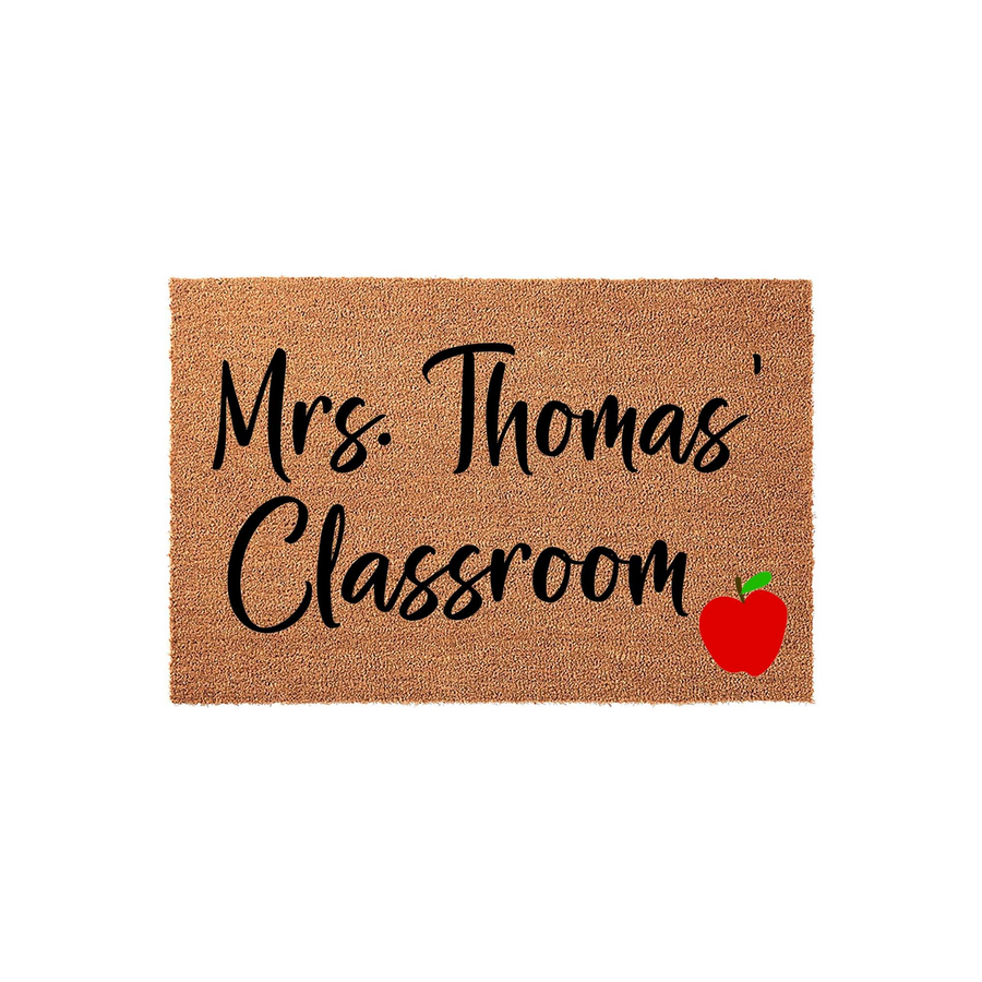 Personalized Teacher Classroom Doormat featuring a natural coir texture with black script text that reads Classroom and a bright red apple icon in the corner, creating a welcoming entrance for any school teacher or educator.