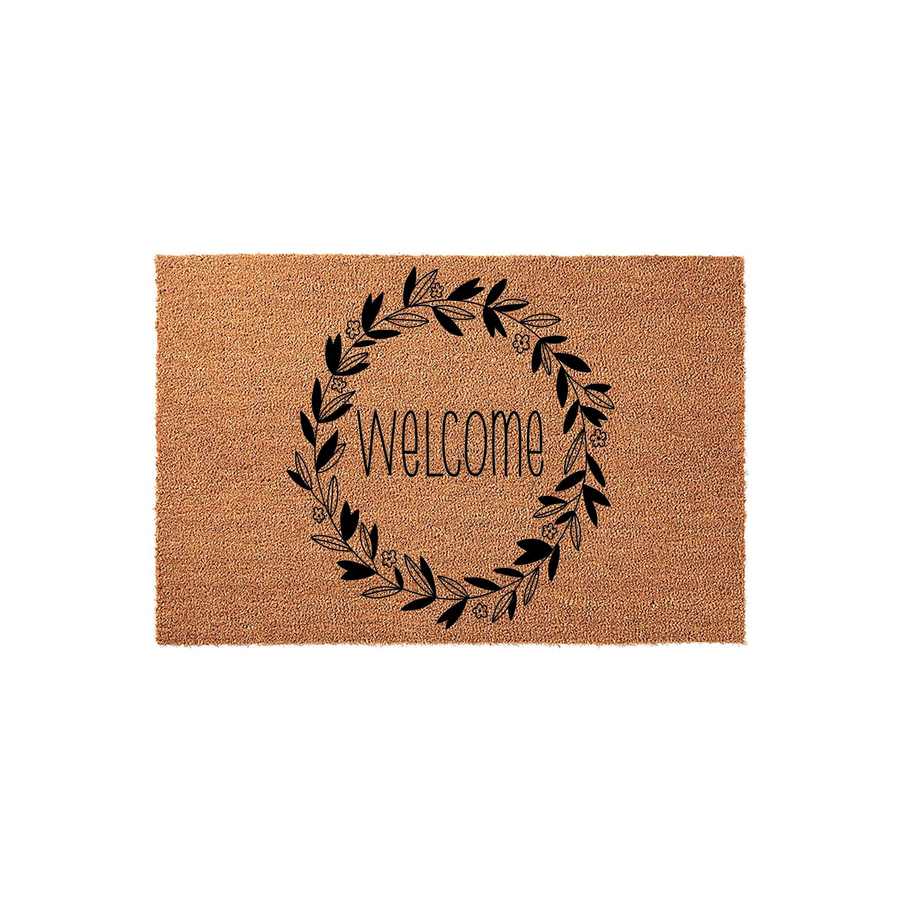 Floral Welcome Doormat featuring a natural coir fiber texture with a black ink design of a circular leaf wreath surrounding the word Welcome in a modern script font, centered on a clean white background for a farmhouse entryway.