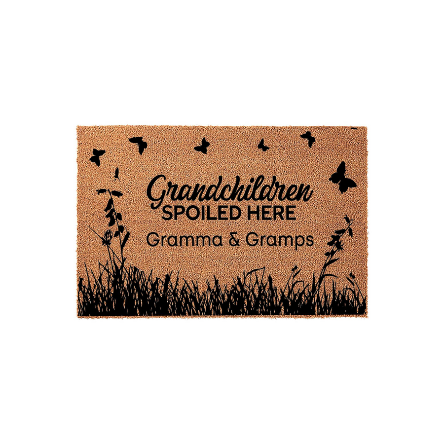 Gramma and Gramps personalized doormat featuring a natural coir texture with black silhouettes of butterflies and tall grass, displaying the text Grandchildren Spoiled Here in a charming script and bold font on a plain white