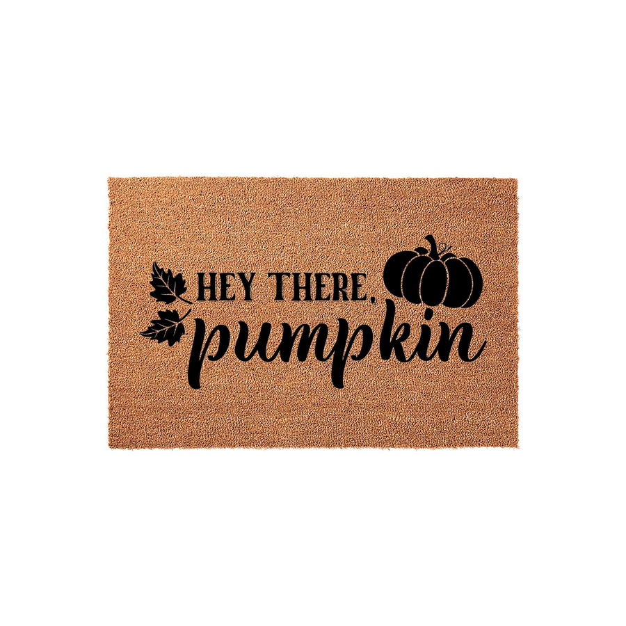 Hey There Pumpkin fall doormat made of natural coir fiber, featuring a black printed design of a large pumpkin and autumn leaves on a rectangular mat, perfect for seasonal front porch decor and welcoming guests to your home this