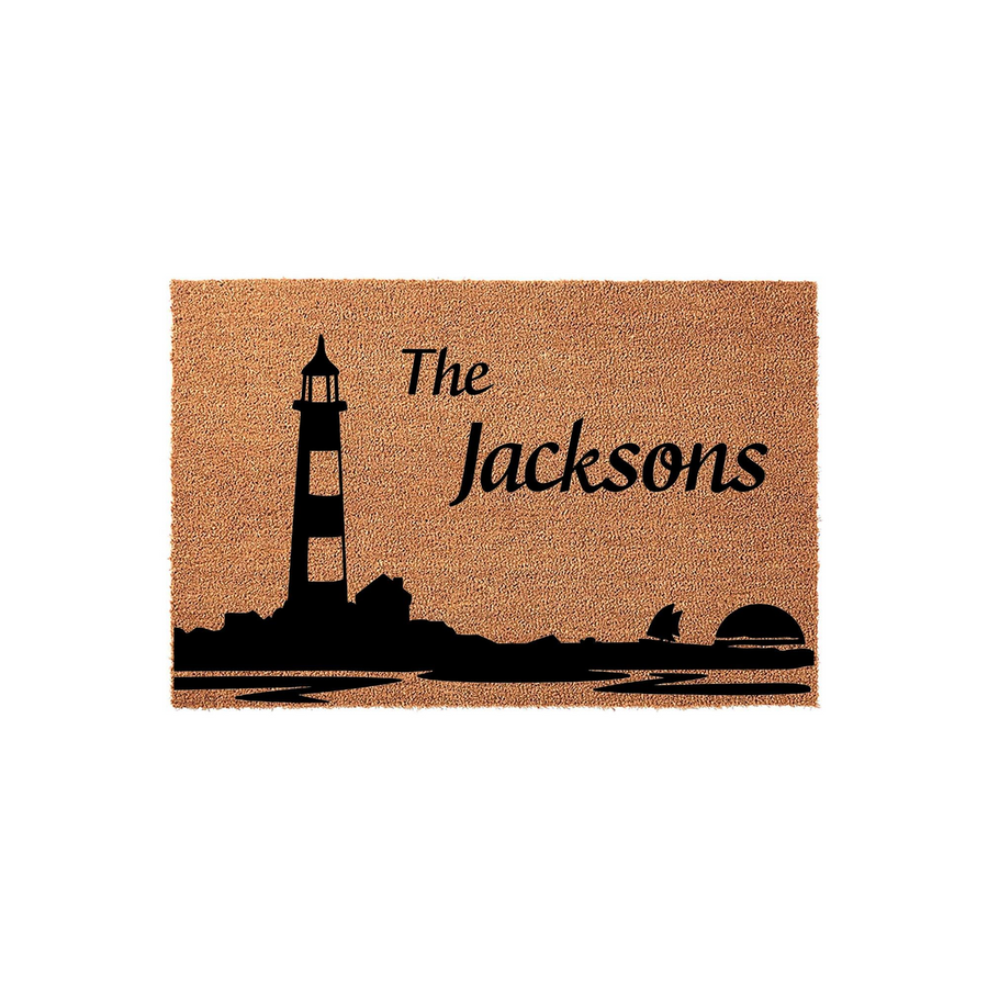 Personalized lighthouse doormat featuring a coastal nautical design on natural coir fiber, customized with a family name to create a welcoming entrance for any beach house or lake home decor style on a clean white background.