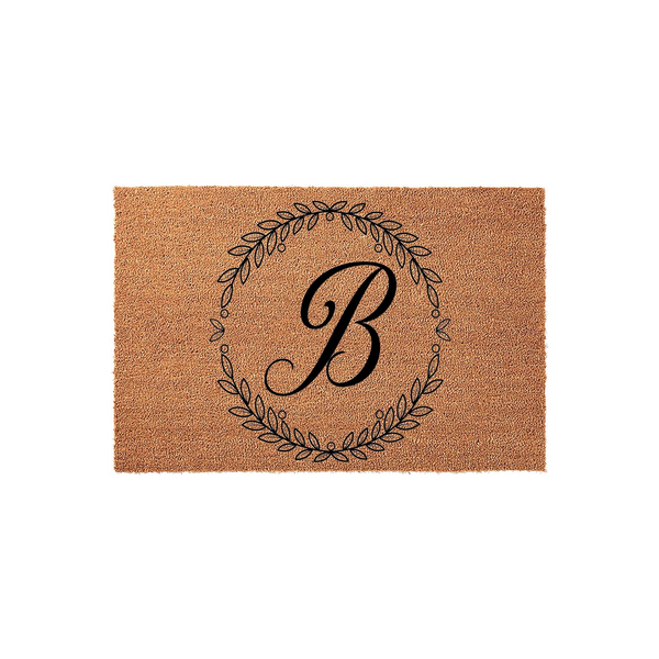 Personalized Monogram Coir Doormat featuring a classic black letter B centered inside a delicate, hand-drawn botanical leaf wreath, providing a stylish and durable welcome mat for your front porch or home entryway decor.