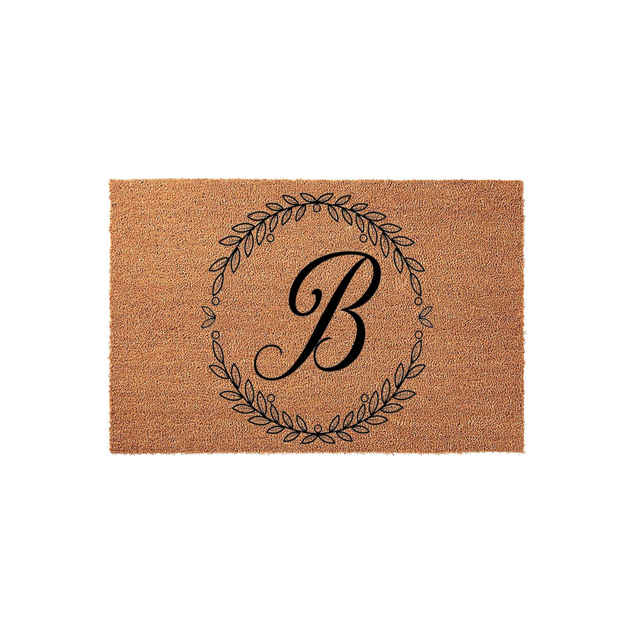 Personalized Monogram Coir Doormat featuring a classic black letter B centered inside a delicate, hand-drawn botanical leaf wreath, providing a stylish and durable welcome mat for your front porch or home entryway decor.