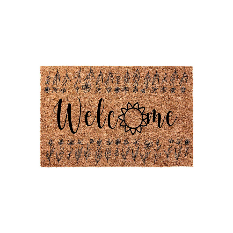 Floral Welcome Doormat featuring a natural coir texture with black ink printing, showcasing a stylized sunflower replacing the letter o and delicate wildflower illustrations bordering the top and bottom edges of the rectangular