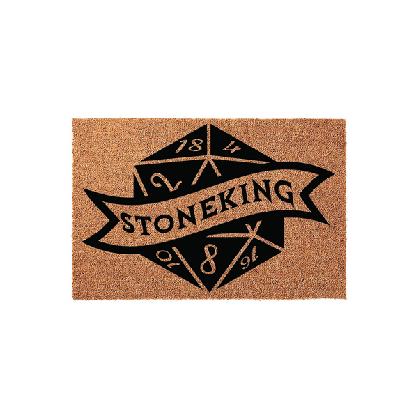 Dungeons and Dragons themed doormat featuring a black printed twenty-sided die graphic with a banner across the center that reads Stoneking, set against a natural tan coir fiber background for a unique tabletop gaming home