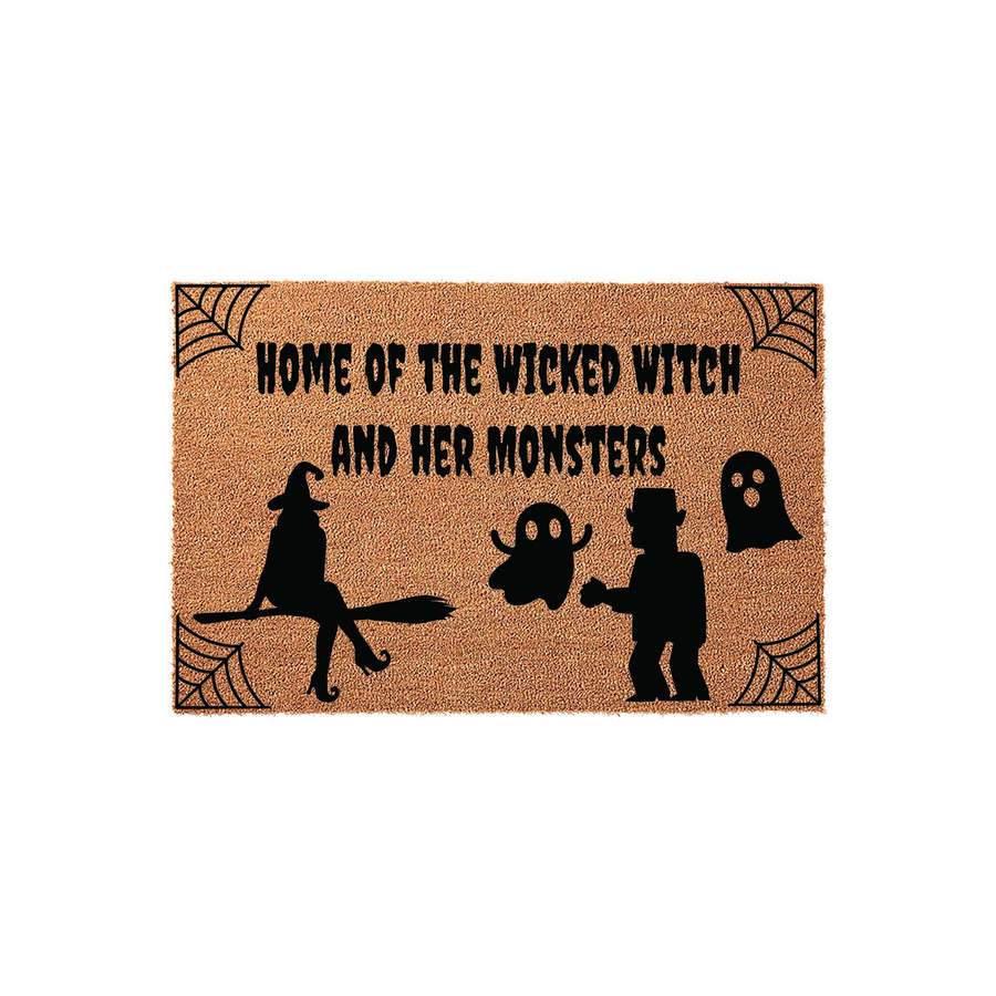 Wicked Witch Halloween Doormat featuring a natural coir texture with black printed text that reads Home of the Wicked Witch and Her Monsters, accented by spooky spider webs, a witch on a broomstick, a ghost, and a monster