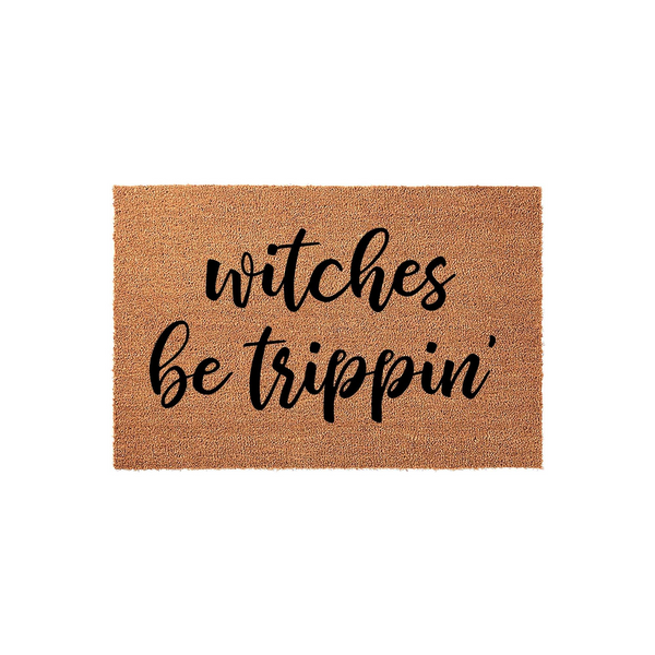 Witches Be Trippin Halloween Doormat featuring a natural coir fiber texture with bold black script lettering, providing a fun and festive seasonal welcome for your front porch entryway during the spooky autumn holiday season.